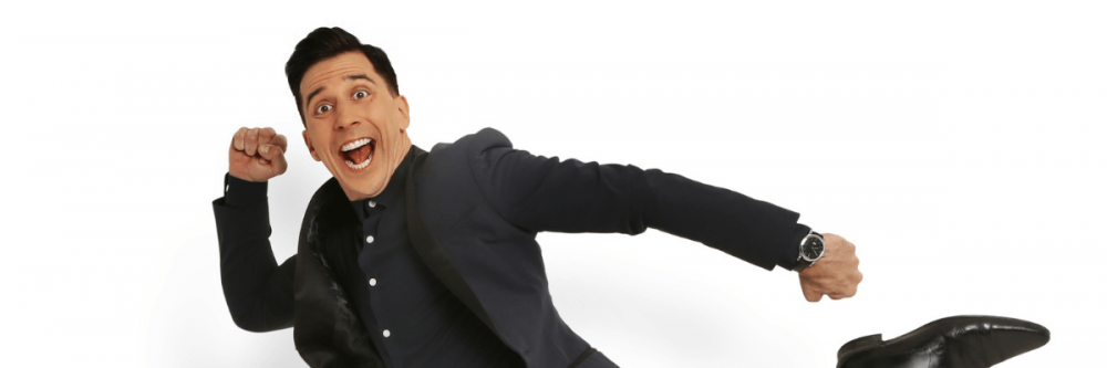 Russell Kane in an exaggerated running position.